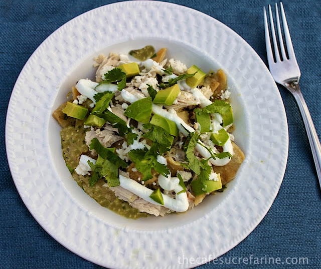Chicken Chilaquiles Verde - thecafesucrefarine.com An overhead photo of a white plate of Chicken Chilaquiles Verde on a blue placemat.
