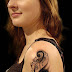 Music tattoo on upper arm of a girl