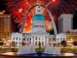 giant rotunda building with Saint Louis Archway behind, colorful fireworks with red, green and blue exploding in background