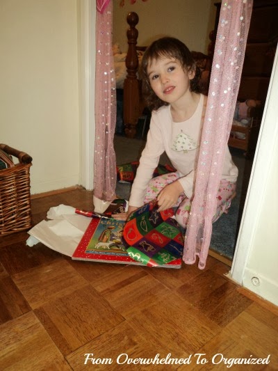 Child unwrapping a book.