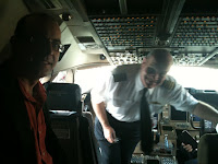 a man in uniform standing in an airplane