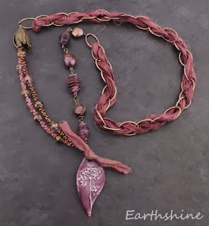 http://earthshine.indiemade.com/product/handmade-lampwork-ceramic-antique-brass-and-silk-ribbon-necklace-mulberry-colour?tid=1