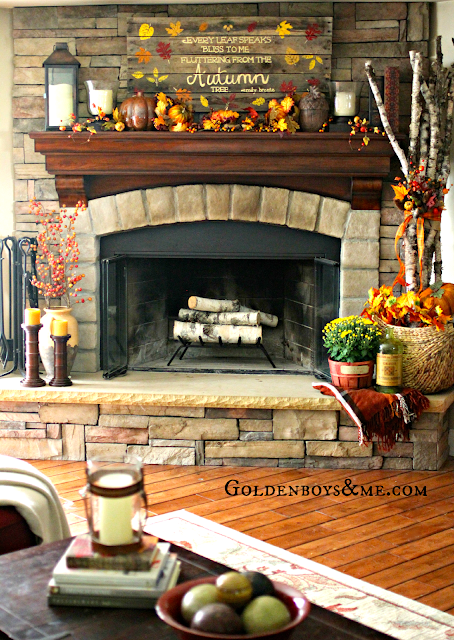 Hand painted and stenciled pallet sign on corner stone fireplace with birch logs, part of Fall Home Tour via www.goldenboysandme.com