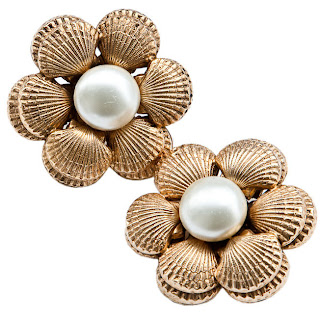Vintage Chanel clip-on earrings made of gold seashells surrounding a pearl in the center.