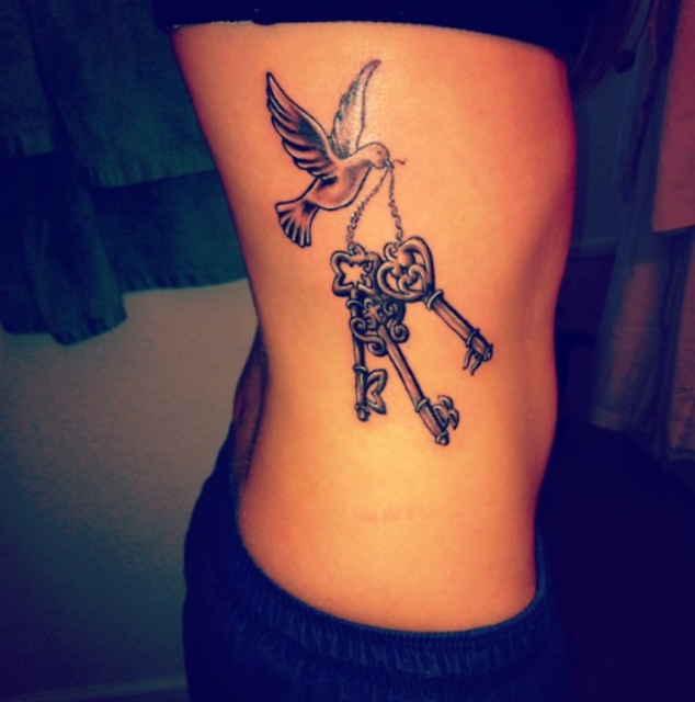 Destiny key tattoo with bird on side body