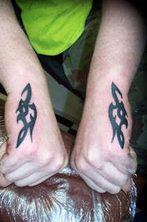 Tattoo Design Art: Matching Tribal Tattoos on Each Arms