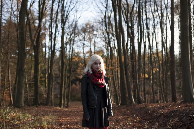 girl in the forest wearing black milk clothing autumn winter forest trees