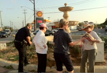 Policeman photographs fountain damage