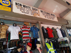 "Apartheid Era" signposts on Diagonal Street shops.