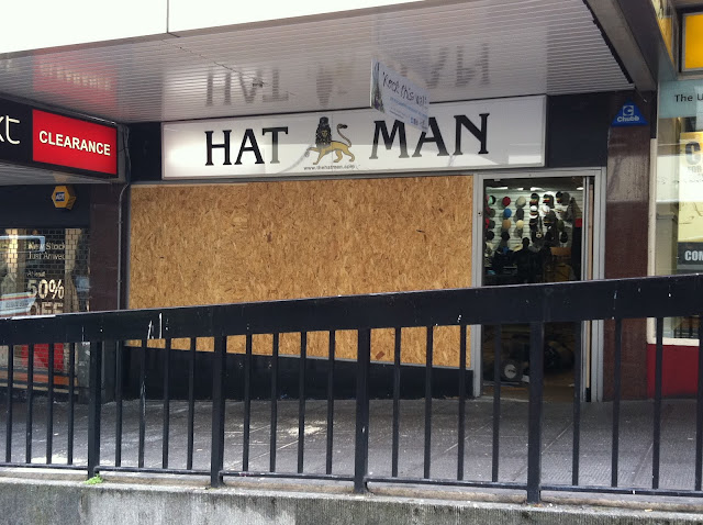 a store front with boarded up windows