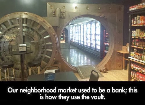 disused bank vault used as a shopping market giant door and hinges of bank vault circular door