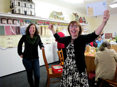 Excited owner of Fairy Meadow Miniatures drawing a lucky door prize.