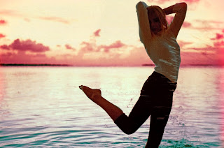 Chloe Moretz at a beach during a sunset