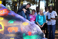 youth pose after painting liberation symbols at the free expression rock