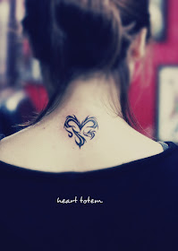 a heart tattoo on the back consist with totem type of lines
