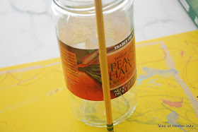 glueing on the first pencil for a pencil vase