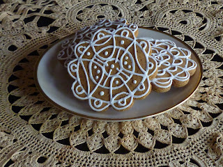 antique hand tatted doily with decorated artisanal gingerbread cookies