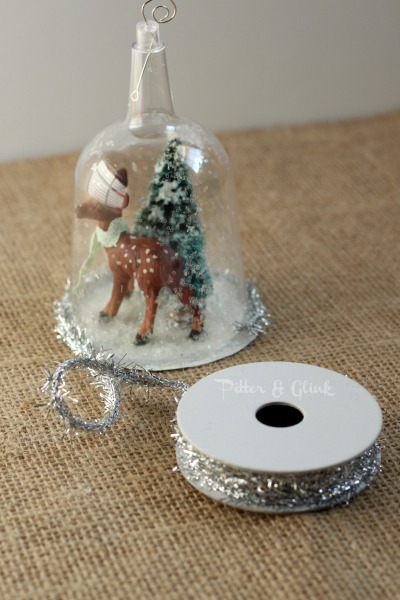 Create a beautiful snow globe ornament from a dollar store plastic wine glass! pitterandglink.com