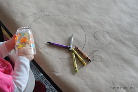 Using craft paper to create a tablecloth for a dinner with kids