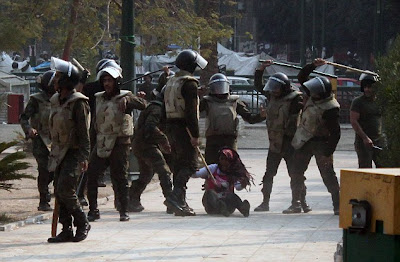 egyptian soldiers beating a woman during protests