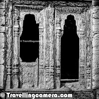 Hope you have enjoyed the journey of first two days with us so far. If you haven't gotten a chance, we recommend to check out Part-1 & Part-2 of the journey and then come back here to enjoy the third day trek to Dhanachuli Village around Kumaun hills. Let's start this Photo Journey to the beautiful Dhanachuli Village.It was bright sunny morning at Dhanachuli and some of us were up at 6:30am. Unpredictable weather during last two days had created so much curiosity that everyone was excited to see bright morning on third day. It opened the gates for the trek to the abandoned village of Dhanachuli. We started from Te Aroha at around 7:00 am. We drove from Te Aroha to the market of Dhanachuli village. We stopped near Bank of Baroda and started our trek downwards through green farms facing snow covered peaks. Mr. Sumant Batra personally led the entire trek and kept us informed about various trees, crops, plants, architecture & people.For initial 20 minutes, we were walking through the habitat area which is comparatively close to the main road which connects Dhanachuli village to other parts of Kumaun. Most of the villagers have pets and mainly cows & goats. Corn crops were all over the farms and some of the farms also had seasonal vegetables - peas, cabbage, bringle, tomatoas, green chillies, kidney-beans (Rajmah) etc. Dhanchuli village is deep in the valley surrounded by snow capped hills on one side and steep green mountains on other side. Dhanachuli hills are probably some of the highest hills in Kumaun region.At the end of the trek were some dilapidated houses of the old Dhanachuli village. Most of the old village is abandoned with only a couple of houses still occupied. The villagers, it seems, have moved to houses closer to the road.The houses were adorned with some interesting carvings and designs. Sumant pointed out some samples of carvings from as far as Rajasthan. He expressed his amazement at finding such designs up here in Uttarakhand. One possible explanation, he thinks, is that these people migrated from the plains over a hundred years ago to escape forced conversions. And with them they carried a part of their memories, tradition, and culture, always wanting to cling on to what they had to leave behind.The houses, though abandoned, still tell a story with their strong foundations, quality material used for building. If you look at the picture above, you will see stones stacked on top of each other. This material is native to the hills and has stood against the test of time.This was one of the houses that was still occupied. A cat was sunning itself on the stairs, while the occupants went about their daily chores. The villagers keep busy most of the times as they need to do almost everything themselves. It is a life full of hardwork and peace.These freshly plucked red chillies and corns have been spread out to dry so that they don't get spoilt when they are stored. The villagers keep some portion of the crops they produce for their personal use, while they sell of the rest. This particular house was so isolated from the rest that we were wondering if the occupants feel afraid at night. We were also asking ourselves what they do to keep themselves entertained. And then we noticed the dish antennae installed outside...but of course...While looking at the exteriors of the abandoned houses, we were curious about the insides. We found an interesting looking house and some of us dared to climb inside. A few of us were worried whether we would chance upon a sleeping leopard inside the house. But Sumant assured us that it wasn't a possibility because if there was a leopard inside, we would be able to smell it before we saw it. Our fear may sound funny to you, but in reality a leopard sighting isn't as rare in these parts. If a cattle is killed or a dog vanishes, the crime is mostly blamed on leopards. Some of the buildings were so beautiful that we were left wondering why no one had noticed them yet. No Bollywood film thriller/ horror film has been shot here, no fashion shoot has been organized with these houses as a backdrop, although the setting is perfect!The last point of the trek was a temple. We sat in the premises and had tea and cookies made by Te Aroha's chef. It was very considerate of Sumant to have thought of this because after the long trek, all of us were dying for a cup of tea. We sat there for about half-an-hour listening to the birds sing and watching the clouds drifting into the valley. We had some interesting conversations while sitting here. We spoke about how inconsiderate it is to build a huge concrete structure on the top of a hill in the mountains. Such things can be very risky for the villagers living below. We discussed how essential it is for development to happen in a responsible way. And during the course of this discussion we discovered that Te Aroha, even though they have taken a water connection from the government's water supply and pay for it, they never use the water. Simply because if the resort starts using the water, hardly anything will be left for the villagers. Instead, Te Aroha has made elaborate arrangements for rainwater harvesting and uses the water they collect from this along with the water from the borer they have installed themselves. After the tea, it was time to head back and this time we chose a different route. Instead of the slippery rocky route, we chose to walk a trail through thefields. En route we stopped and tasted some very sweet peas, and met some local children who were more than happy to oblige us with generous smiles. The morning was a tiring one and yet gratifying. And we felt exercised and yet relaxed at the end of it. More than anything else the trek provided a lot of food for thought and we dwelled on it for quite some time.