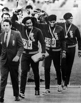 LEE+EVANS,+LARRY+JAMES,+AND+RONNIE+FREEMAN+ACCESSORIZE+THEIR+MEDALS+WITH+BLACK+PANTHER-SOLIDARITY+BERETS+AT+THE+'68+MEXICO+CITY+OLYMPICS..jpg