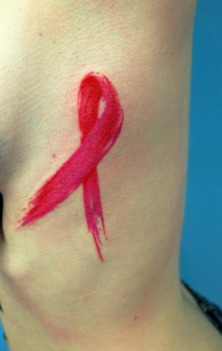 Cancer ribbon tattoo on side body