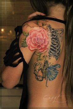 Pink flower and rib cage tattoo on side back shoulder