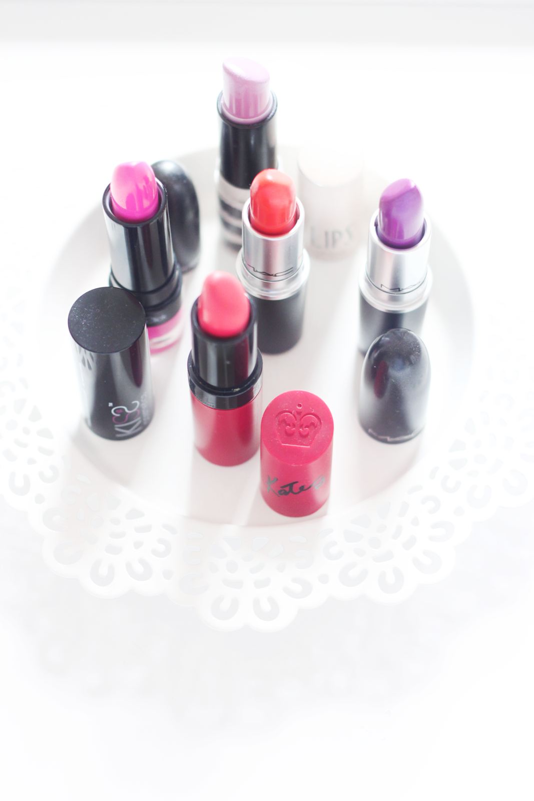 a picture of KISSstick Toxic Kiss, Rimmel Kate Moss 110, Topshop On The Town, MAC Cosmetics Violetta, Morange