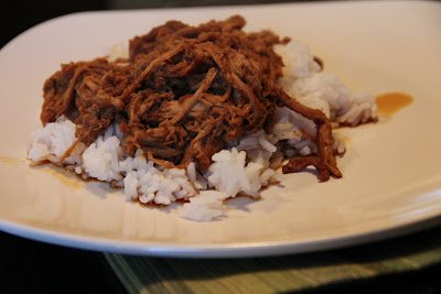 char siu pork over rice on white plate