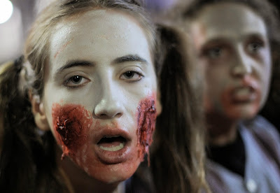 People dressed as zombies take part in a Zombie Walk in Sitges, near Barcelona, on October 12, 2013.