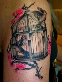 Birdcage and flower tattoo on arm