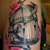 Birdcage and flower tattoo on arm