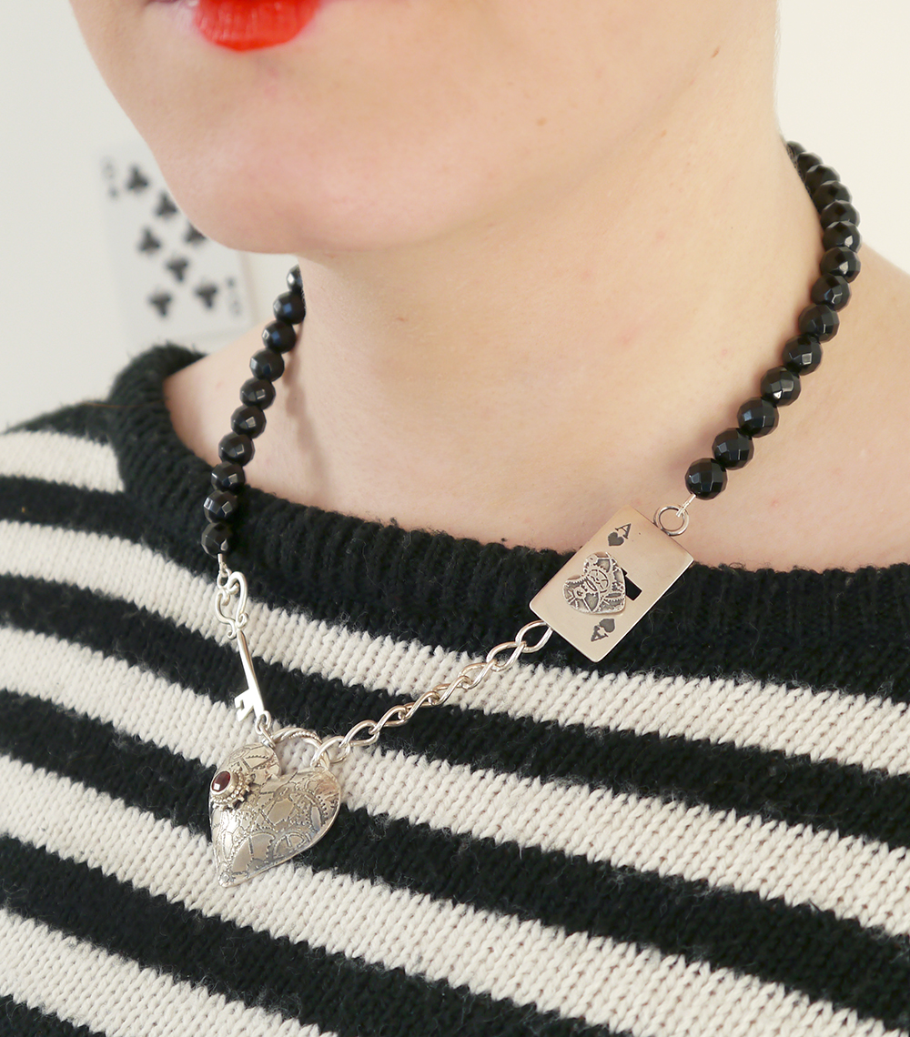 Karen Smith Heart Necklace Queen of Hearts, Alice in Wonderland, Queen of Hearts outfit, red queen, literary style, Karen Smith jewellery, heart jewellery, Dundee jewellery, Dundee design, Scottish jewellery design, red hair, dinger, Scottish blogger, pack of cards, Iolla glasses, clear glasses, red lips, doll lips, stripey jumper, gold skirt, red glitter hearts