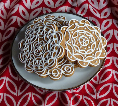 modern tulip pattern in red with plate of decorated gingerbread cookies