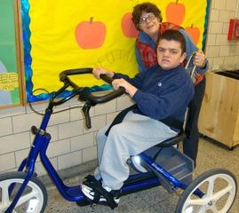 Susan Maltz observes Matt as he rides his bike at the BEST Program.