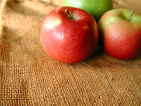 Photograph of two rosy apples. Two can mean two opposite, or times two or double strength.