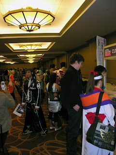 Attendees waiting in the registration hallway