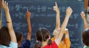  students raising their hands to ask a question.