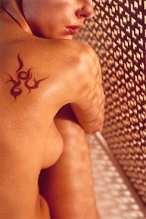 Small Tribal Symbol Tattoo on Girls Upper back