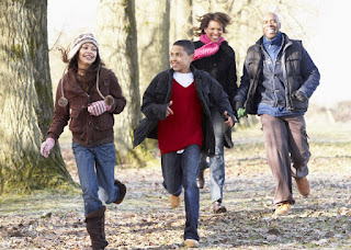 family enjoying a brisk walk/run on trail together