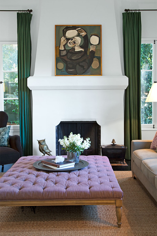 A large square lavender ottoman matches beautifully the emerald pops in the living room of Ginnifer Goodwin. Photo by Hilary Walsh via Elle Decor.