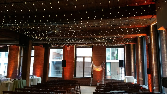Canopy of mini-led string lights / twinkle lights suspended between the center columns at The Dumbo Loft