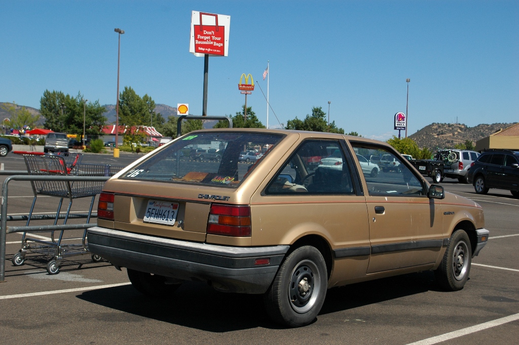 OLD PARKED CARS. 1986 Chevrolet Spectrum 2door hatchback.