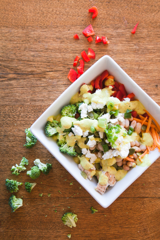 Seattle Sunshine Bowl – a bowl of goodness – quinoa, grilled chicken, white beans, chopped veggies, pumpkin seeds, feta, and scallions, all topped with a yellow Sunshine Sauce.