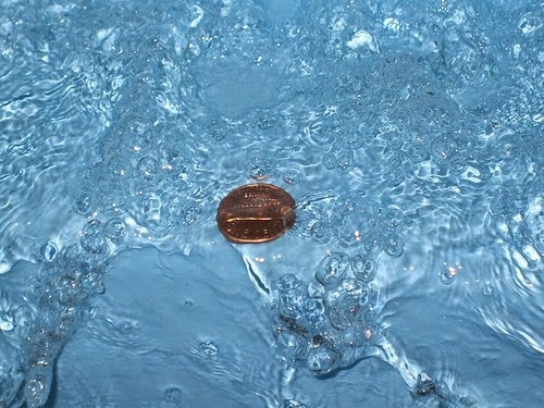 Coin in water tradition, India