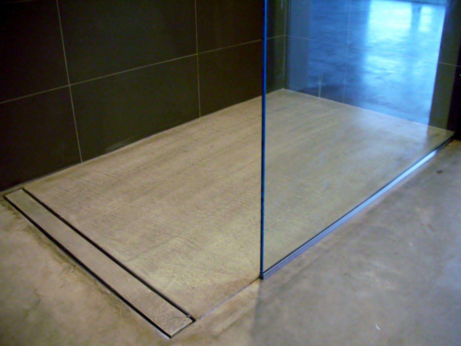 bathroom shower systems Open Concept Bathroom - featuring a concrete floor, a curbless shower 