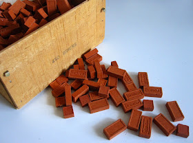 Wooden box of miniature bricks.