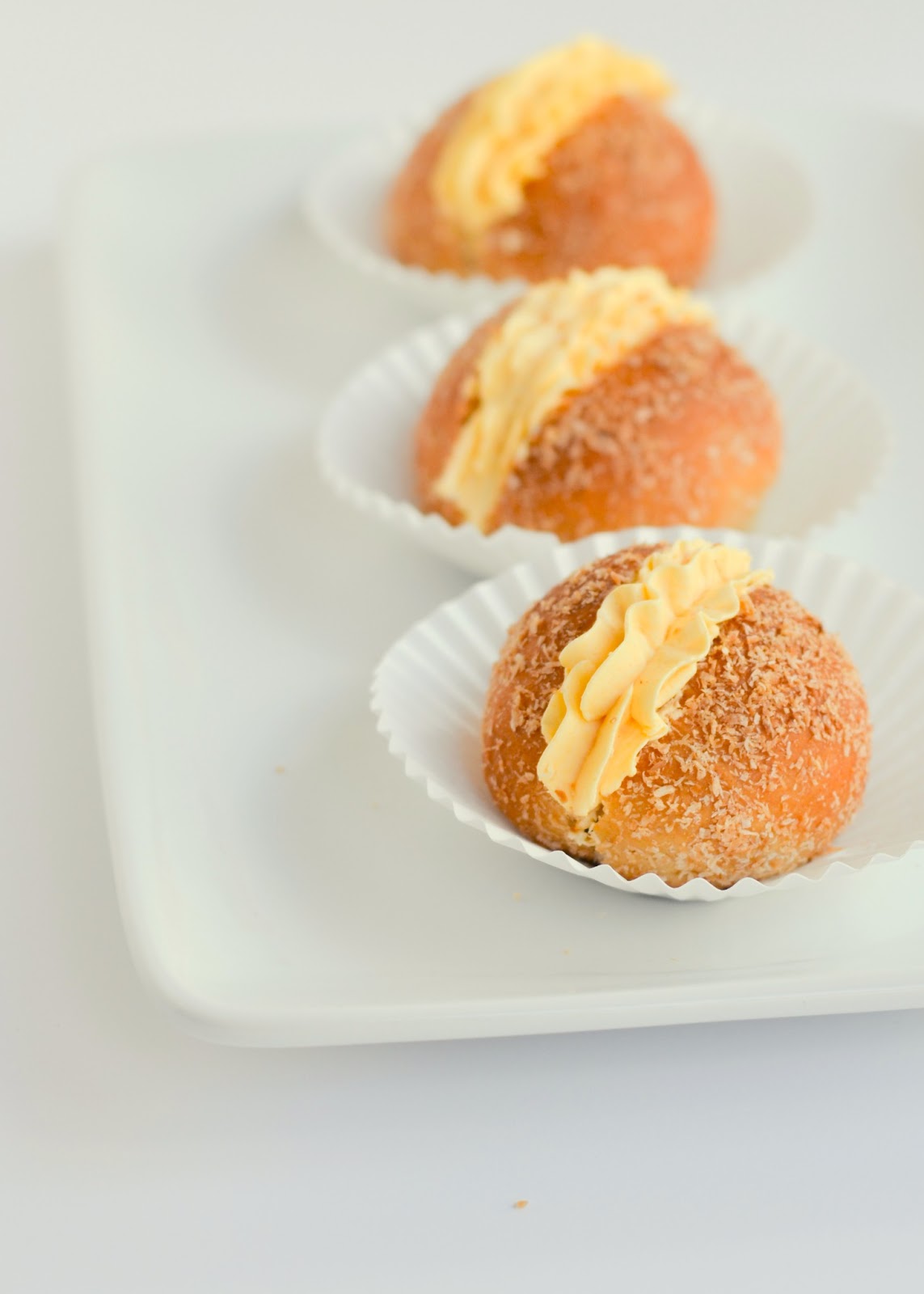 Mini Coconut cream buns evoking comfort for a weary family. The moonblush Baker