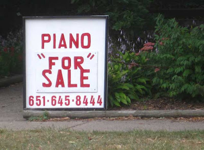 Hand-painted sign reading PIANO FOR SALE with FOR inside double quotation marks